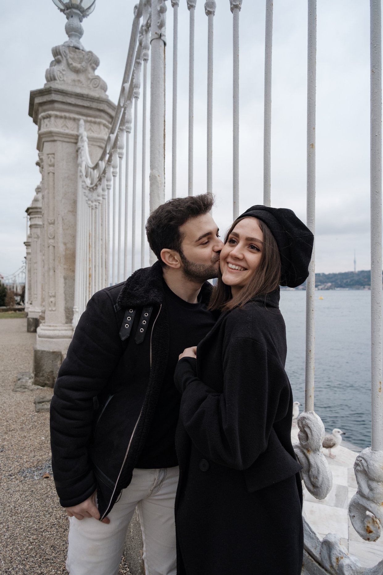 Couple Posing Near White Fence in Istanbul